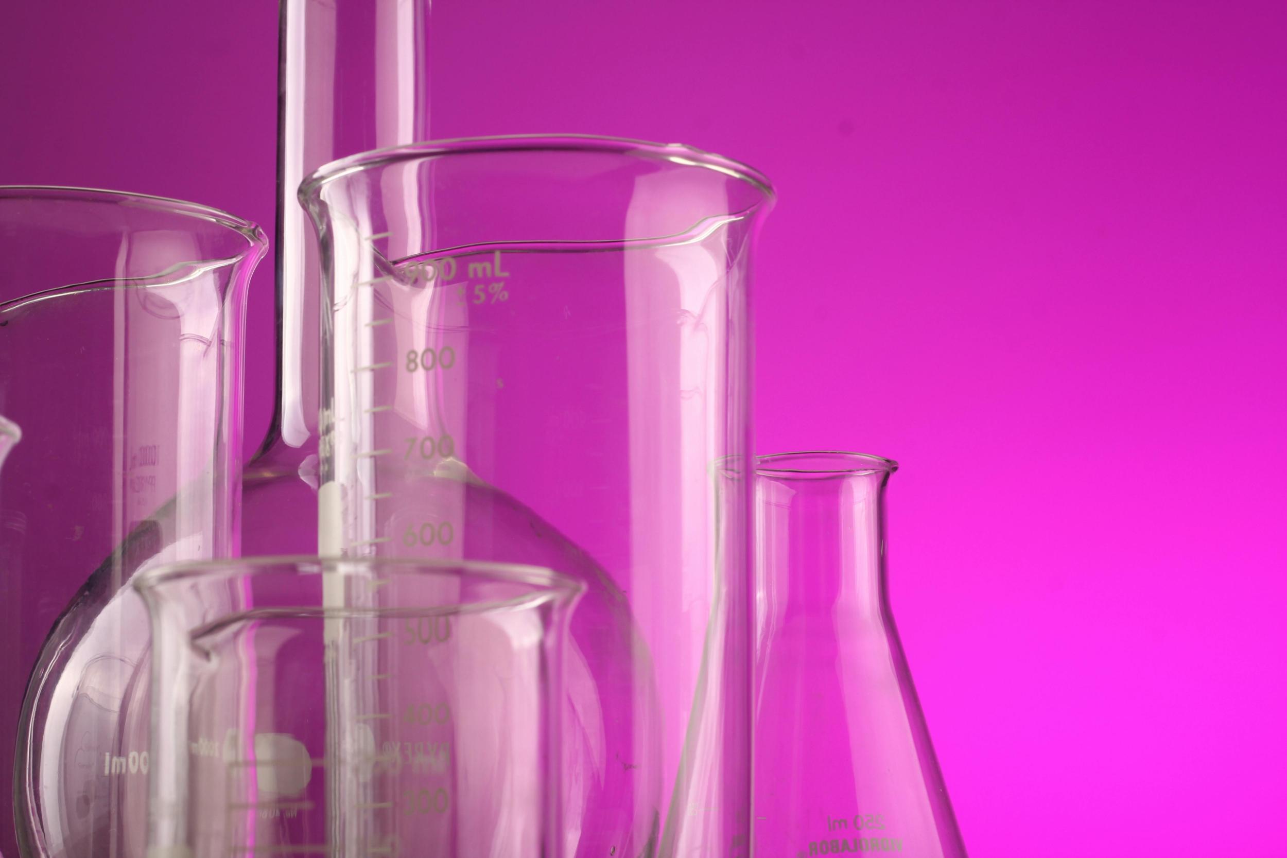 Understanding email marketing metrics - image of glass measuring vessels on a cerise background