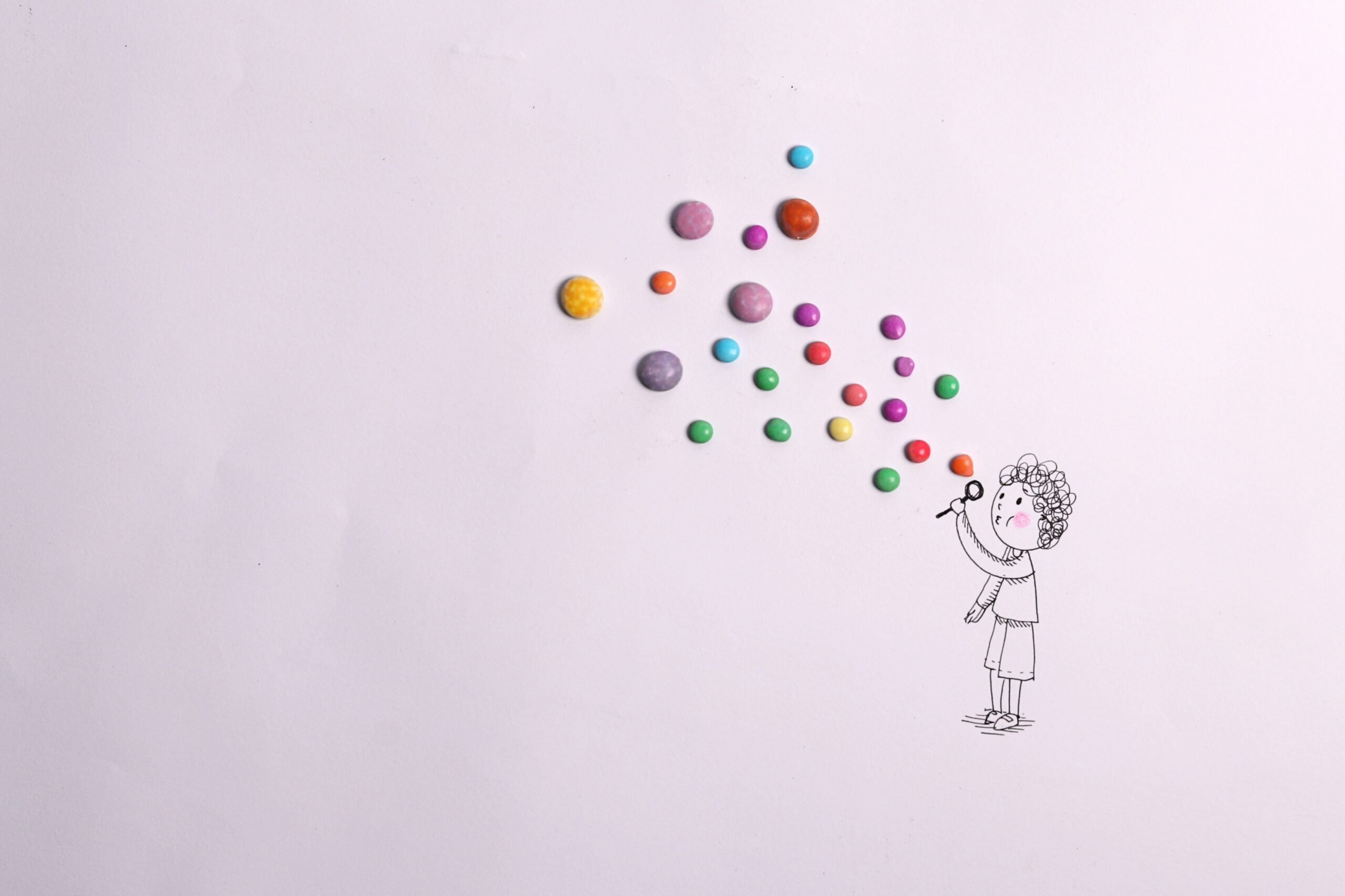 Don't panic! A straight forward guide to SEO in the age of AI - line drawing of a girl blowing multi-coloured bubbles made of coloured sweets