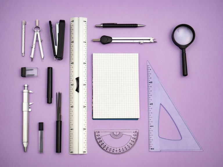 How to measure marketing campaign success - image of a variety of measuring tools including ruler, set square, compasses, and a spyglass on a purple background