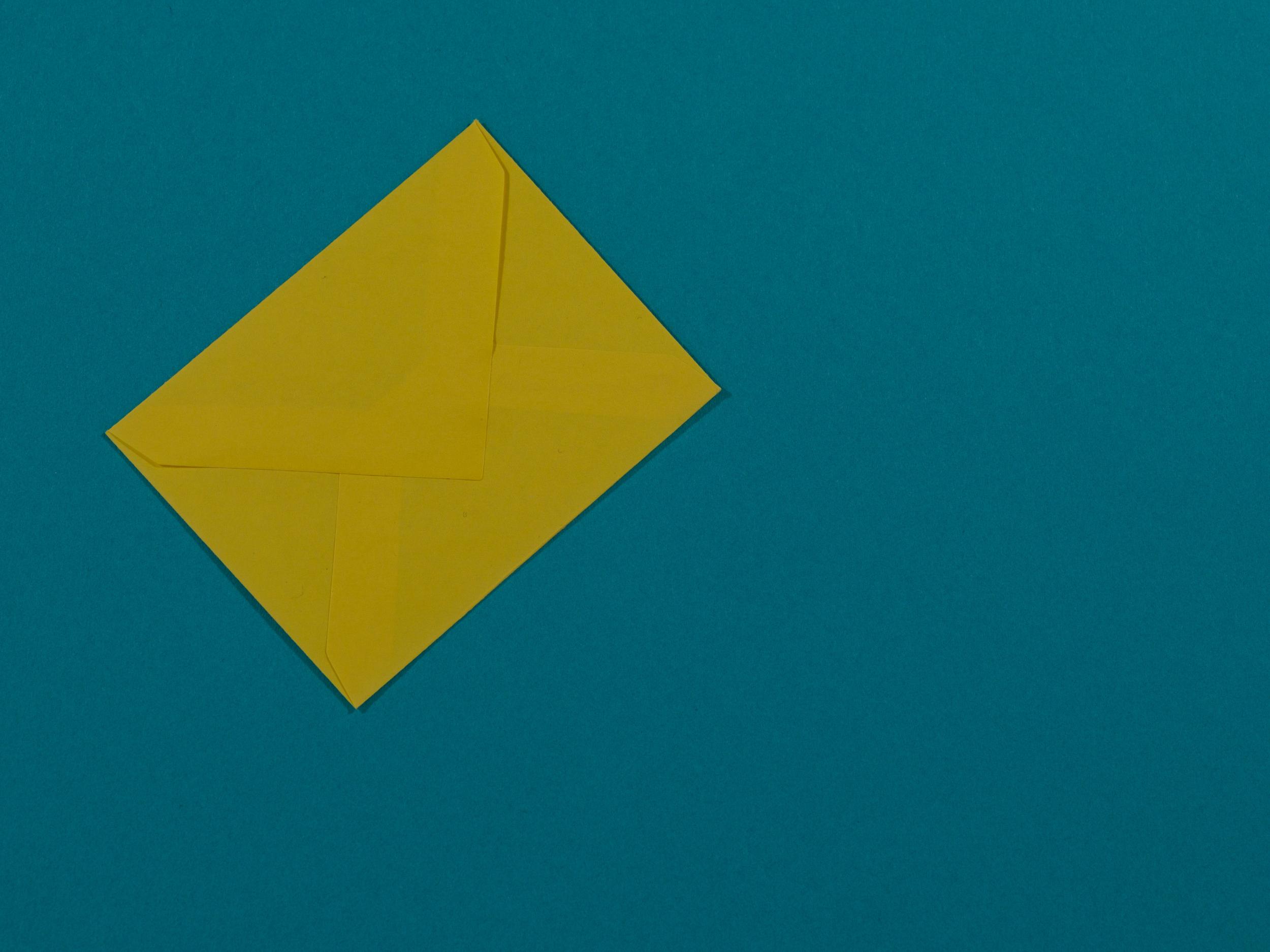 Is email marketing dead? Image of a yellow envelope on a teal background
