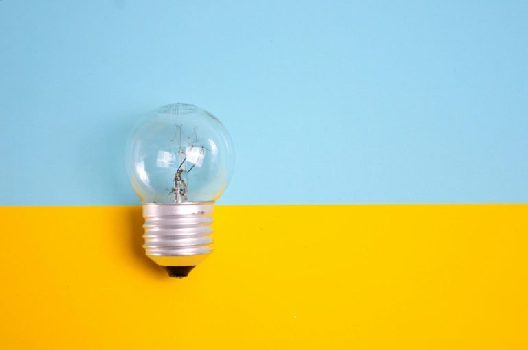 Is your Q1 marketing strategy on track? Image of a lightbulb on a blue and yellow background