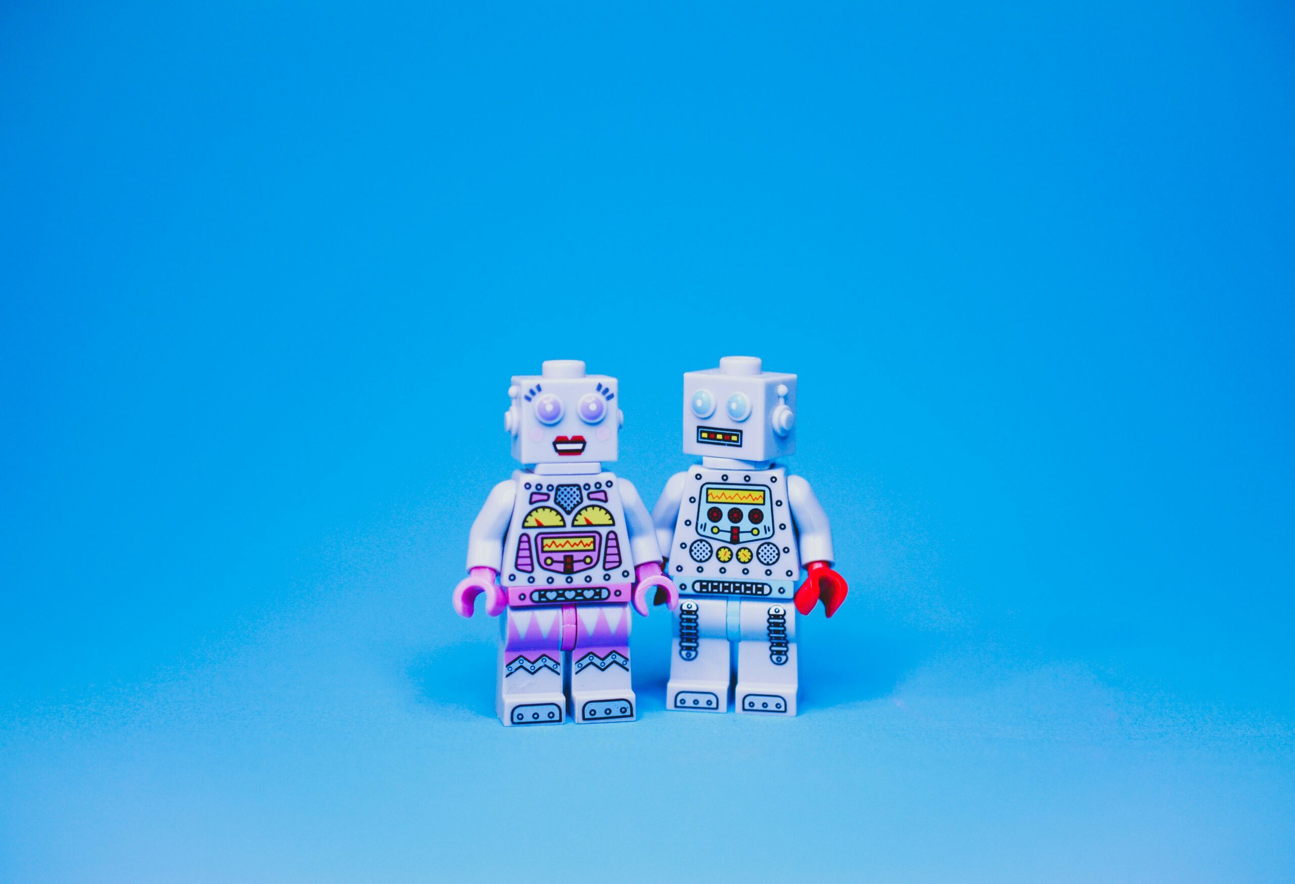 The limitations of AI in marketing - image of 2 lego robot minifigs trying to hold hands
