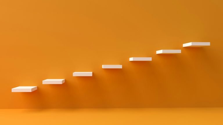 How to measure SEO success - image of floating steps on an orange wall