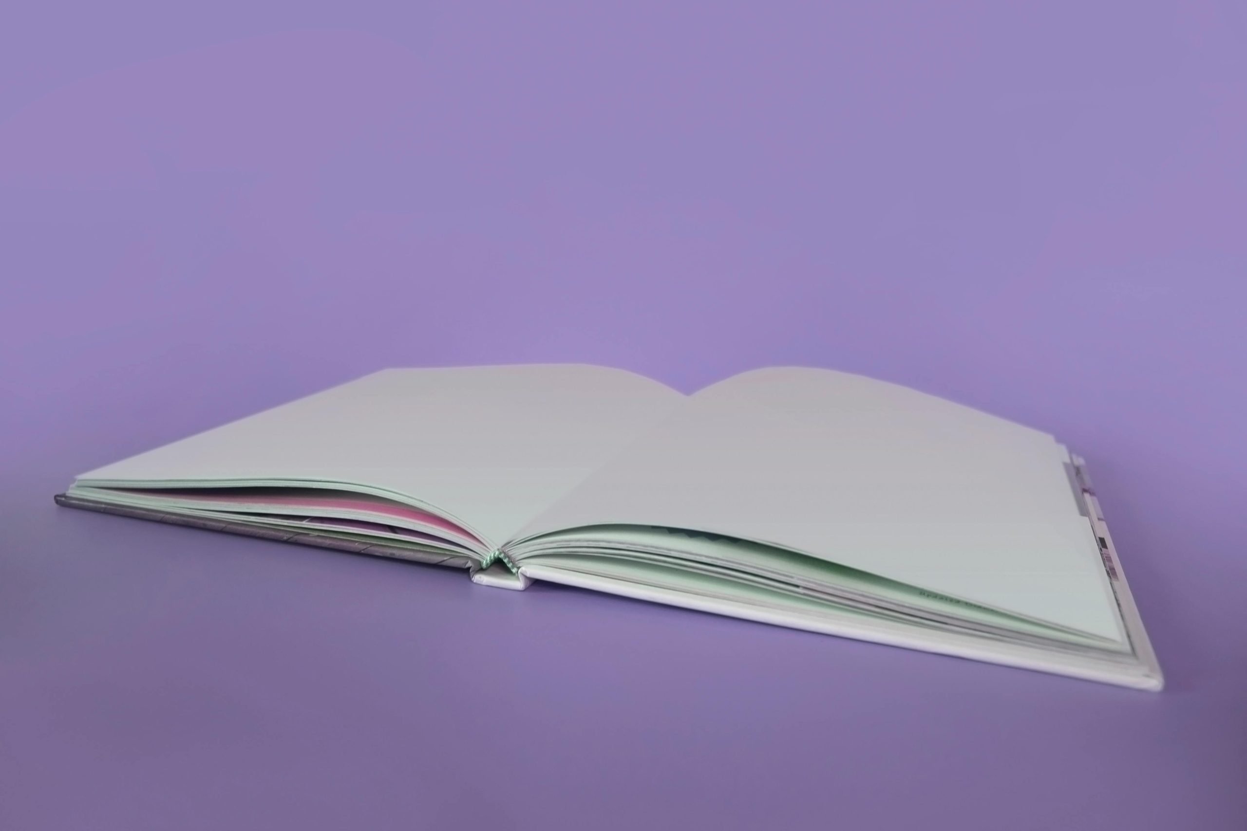 A Q4 marketing plan that doesn’t involve spreadsheet hell - image of an open blank notebook full of possibility and ready for ideas on a purple background