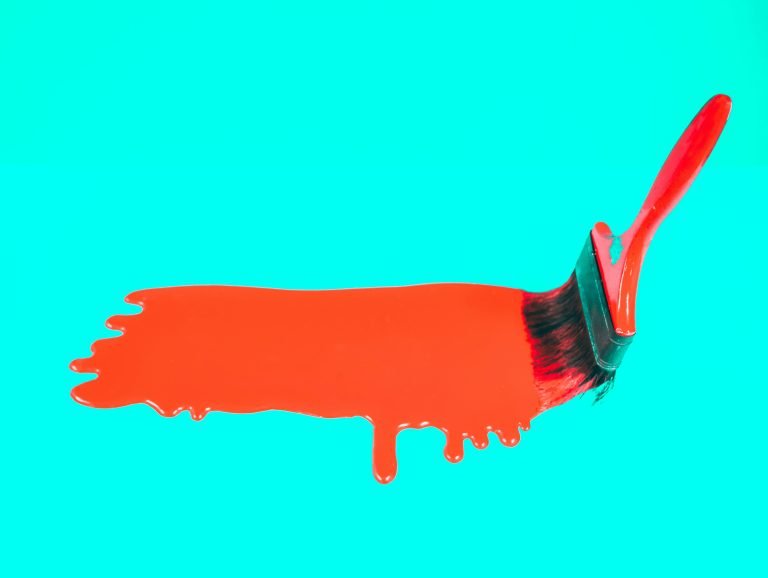 What makes a successful marketing campaign? - Image of a red paintbrush painting red paint on an aqua background