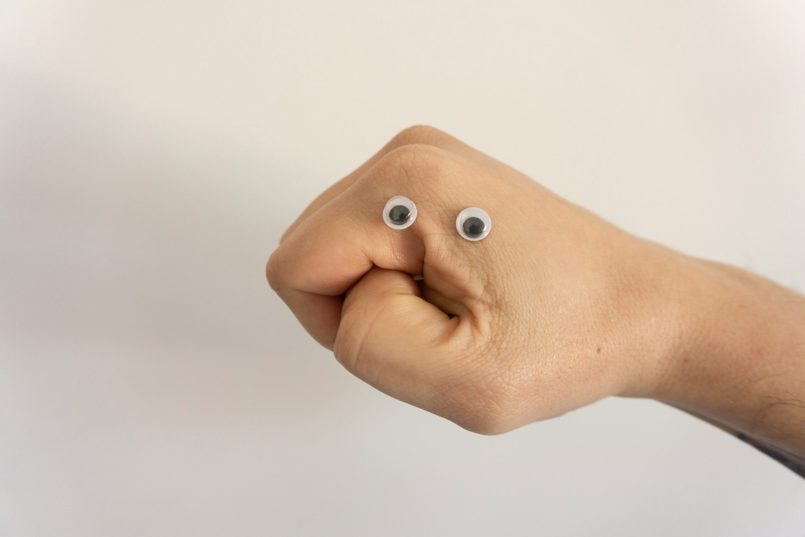 What AI search means for small business websites - images of a fist making a face with googly eyes