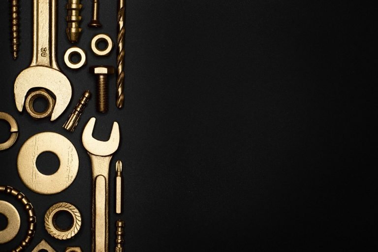 What is a CMS? It's a tool! So here's a picture of some gold tools on a black background