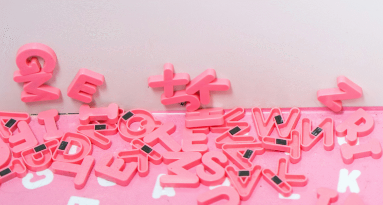 Write with Purpose - images shows magnetic letters falling and arranged on the ground.